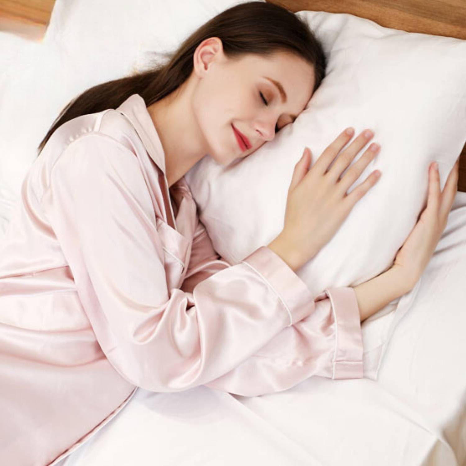 Woman asleep in the pink silk pyjamas
