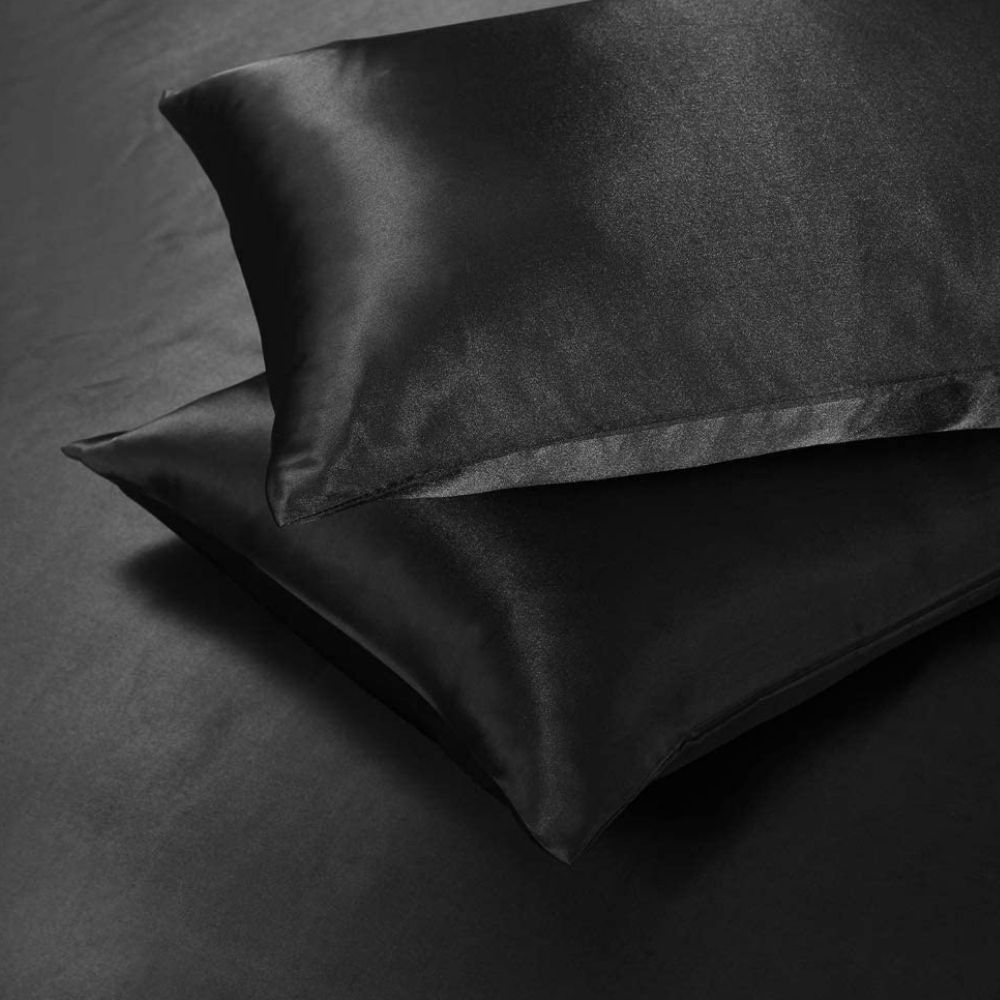 Black satin duvet cover and pillowcases on a bed