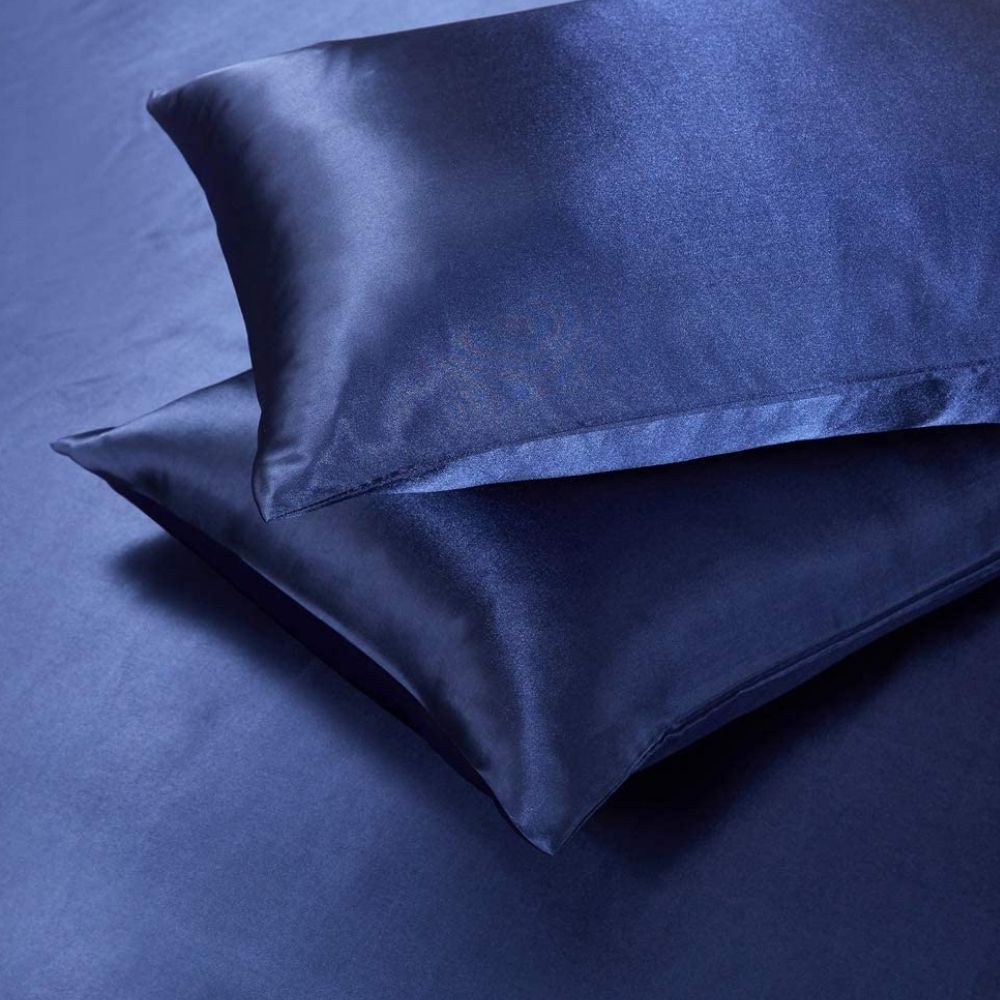 Blue satin duvet cover and pillowcases on a bed