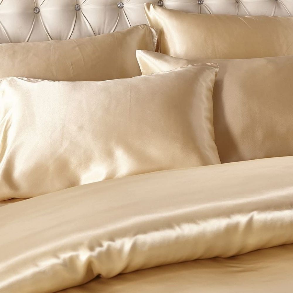 Gold satin duvet cover and pillowcases on a bed