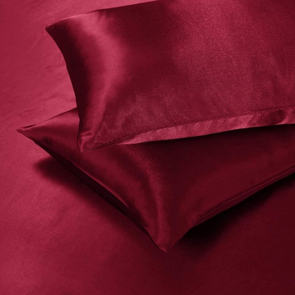 Red satin duvet cover and pillowcases on a bed