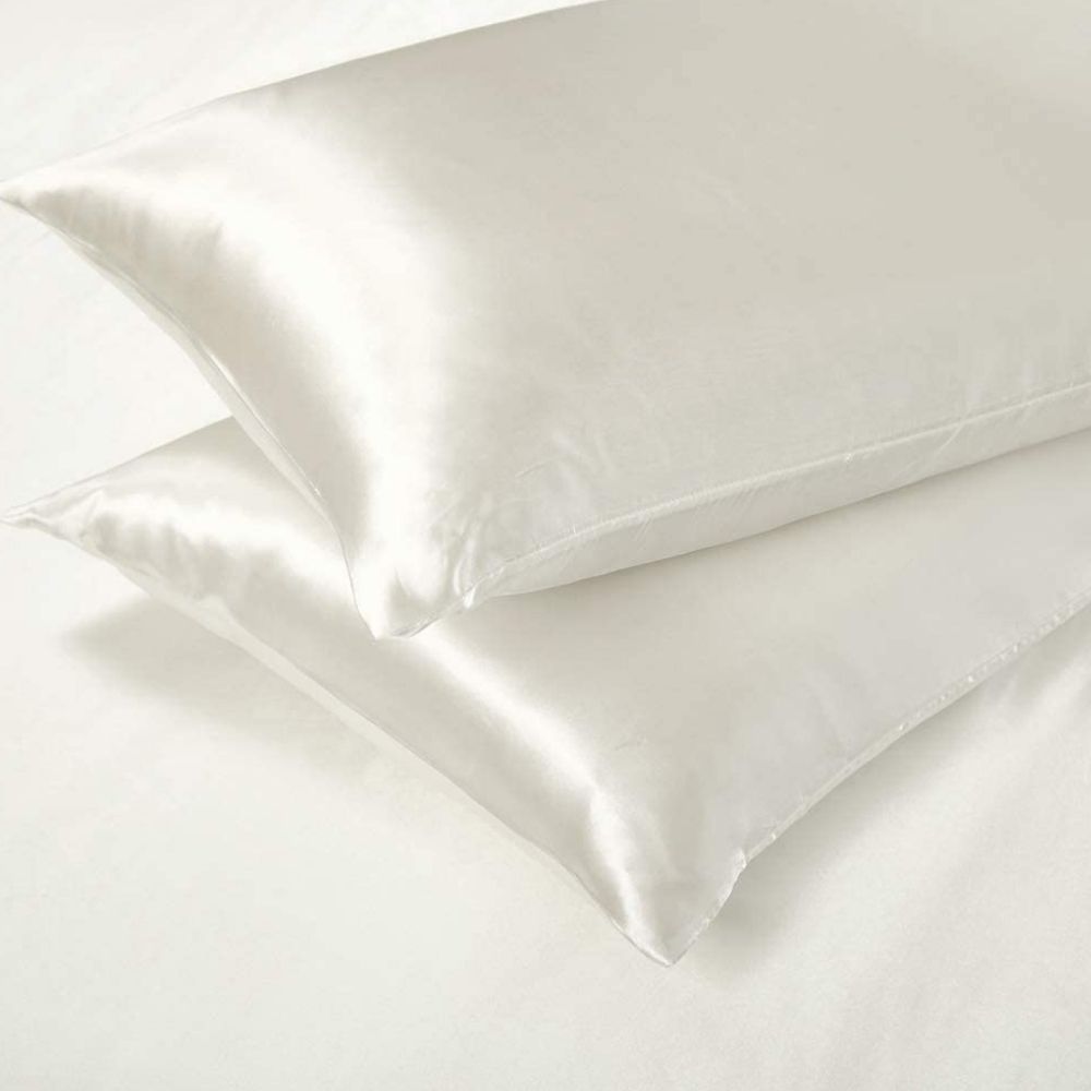 White satin duvet cover and pillowcases on a bed