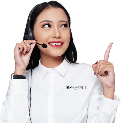 Customer support agent with a headset, wearing a Silk Pyjamas Company shirt
